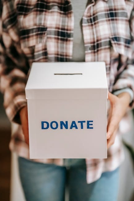 charity and support Close-up of a person holding a 'donate' box, encouraging charity and support.